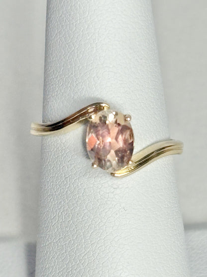 14k gold bypass ring with an oval light peach Oregon sunstone.