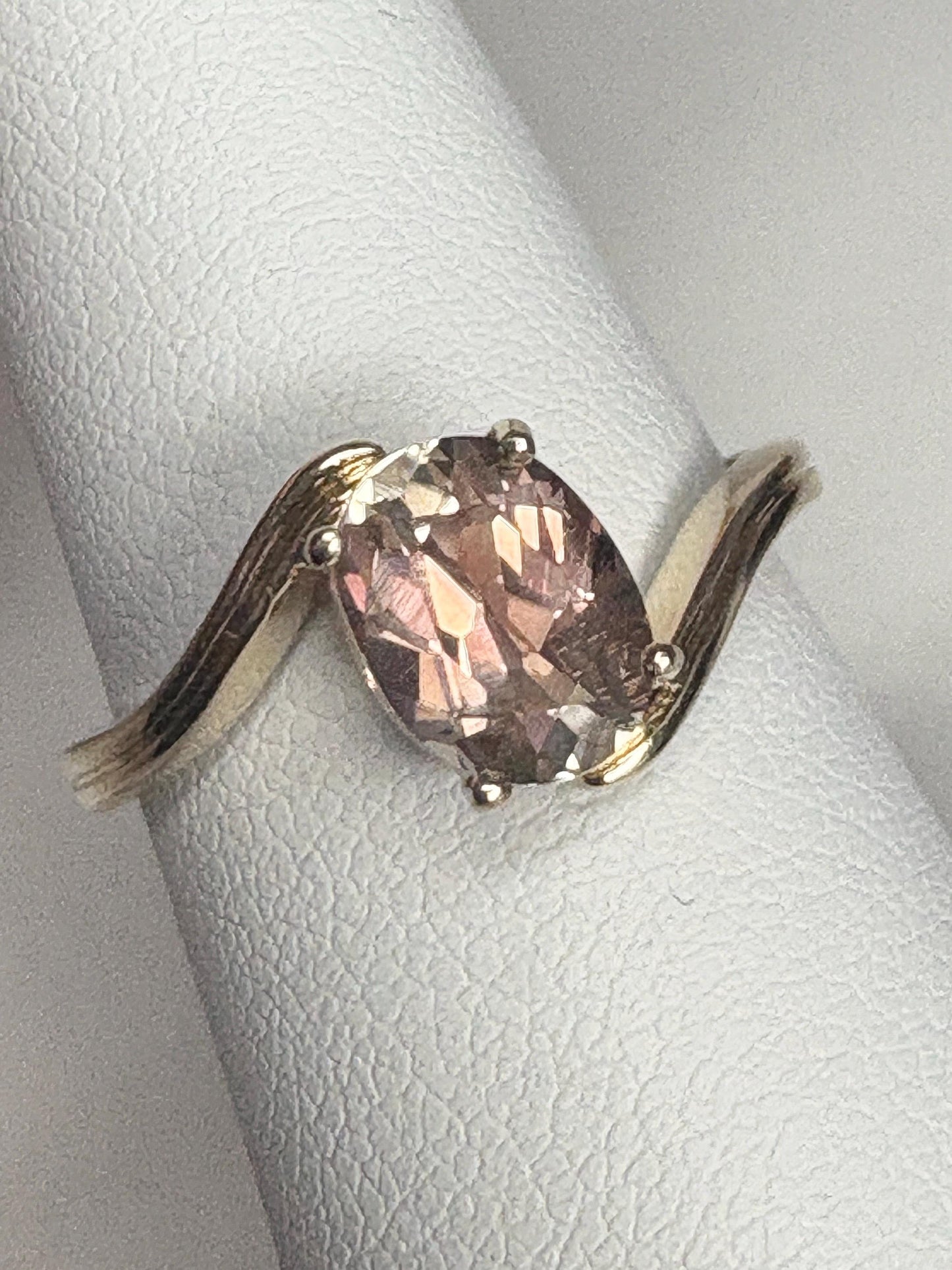 Oval light peach Oregon sunstone solitaire bypass ring in 14k gold.