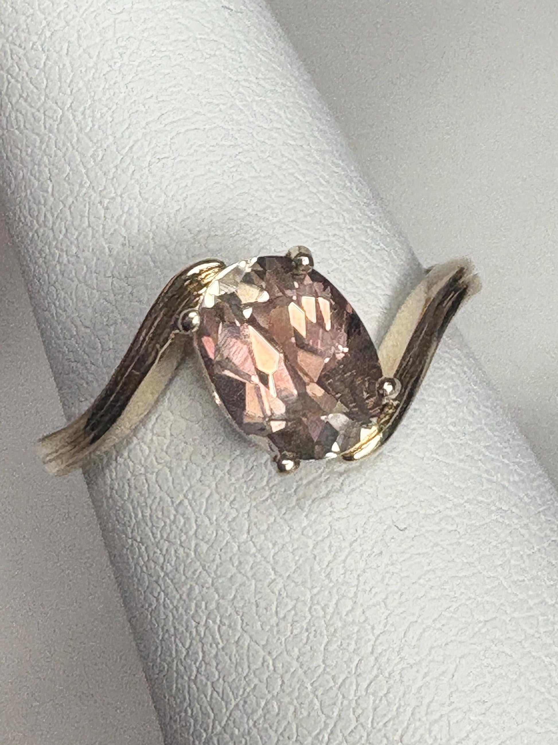 Oval light peach Oregon sunstone solitaire bypass ring in 14k gold.