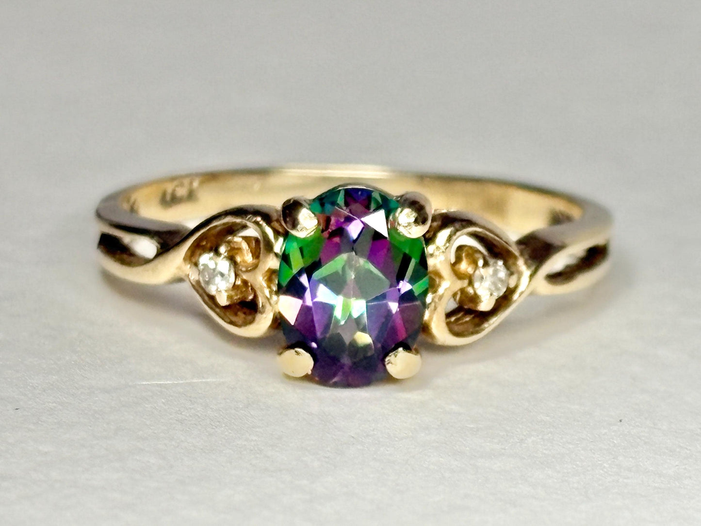 10k yellow gold ring with oval mystic topaz and two diamonds.