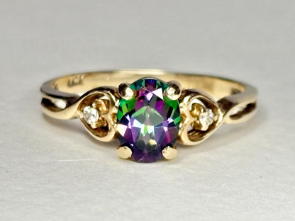 10k yellow gold ring with oval mystic topaz and two diamonds.