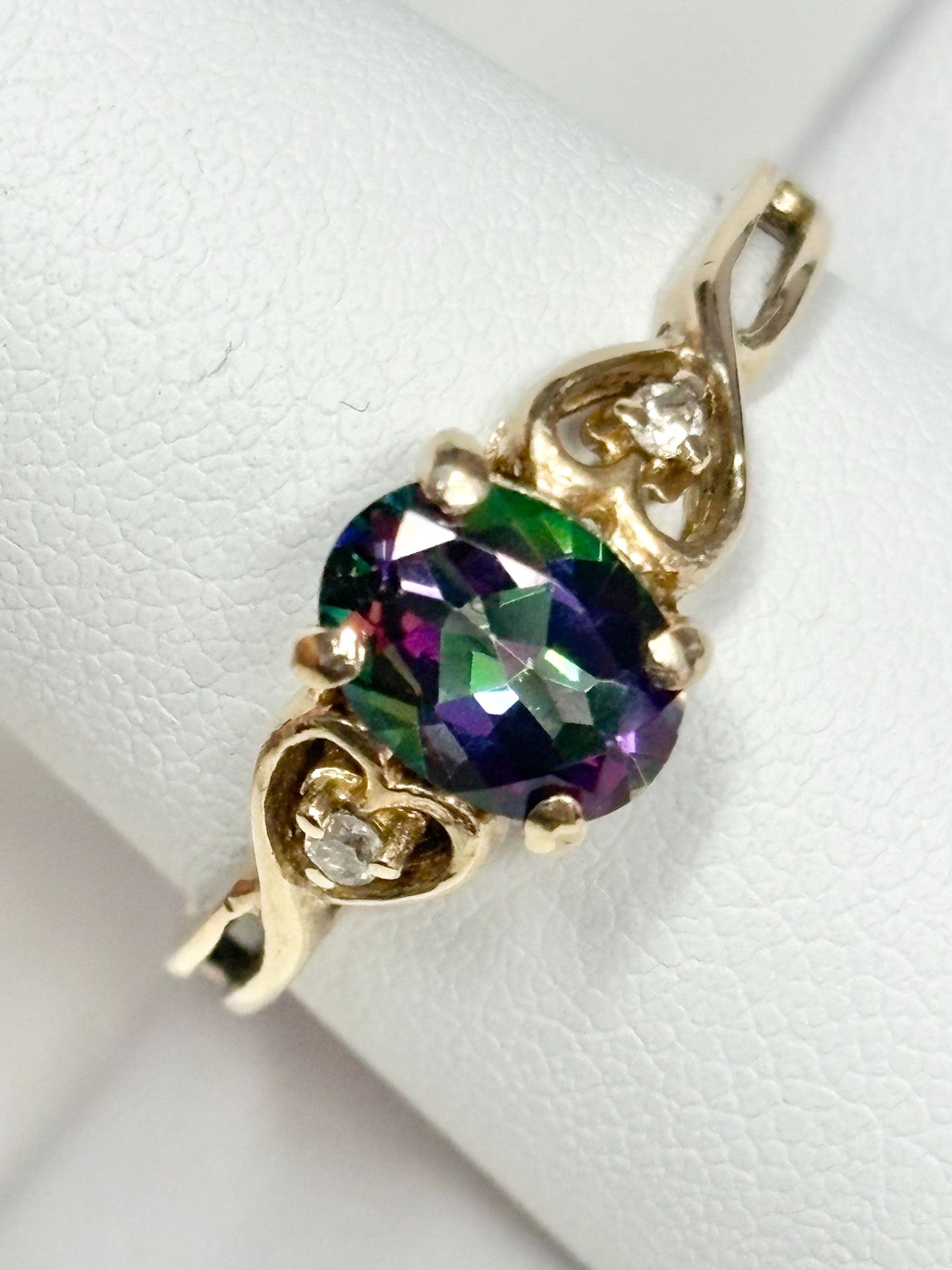 10k gold ring with oval mystic topaz and two diamonds.