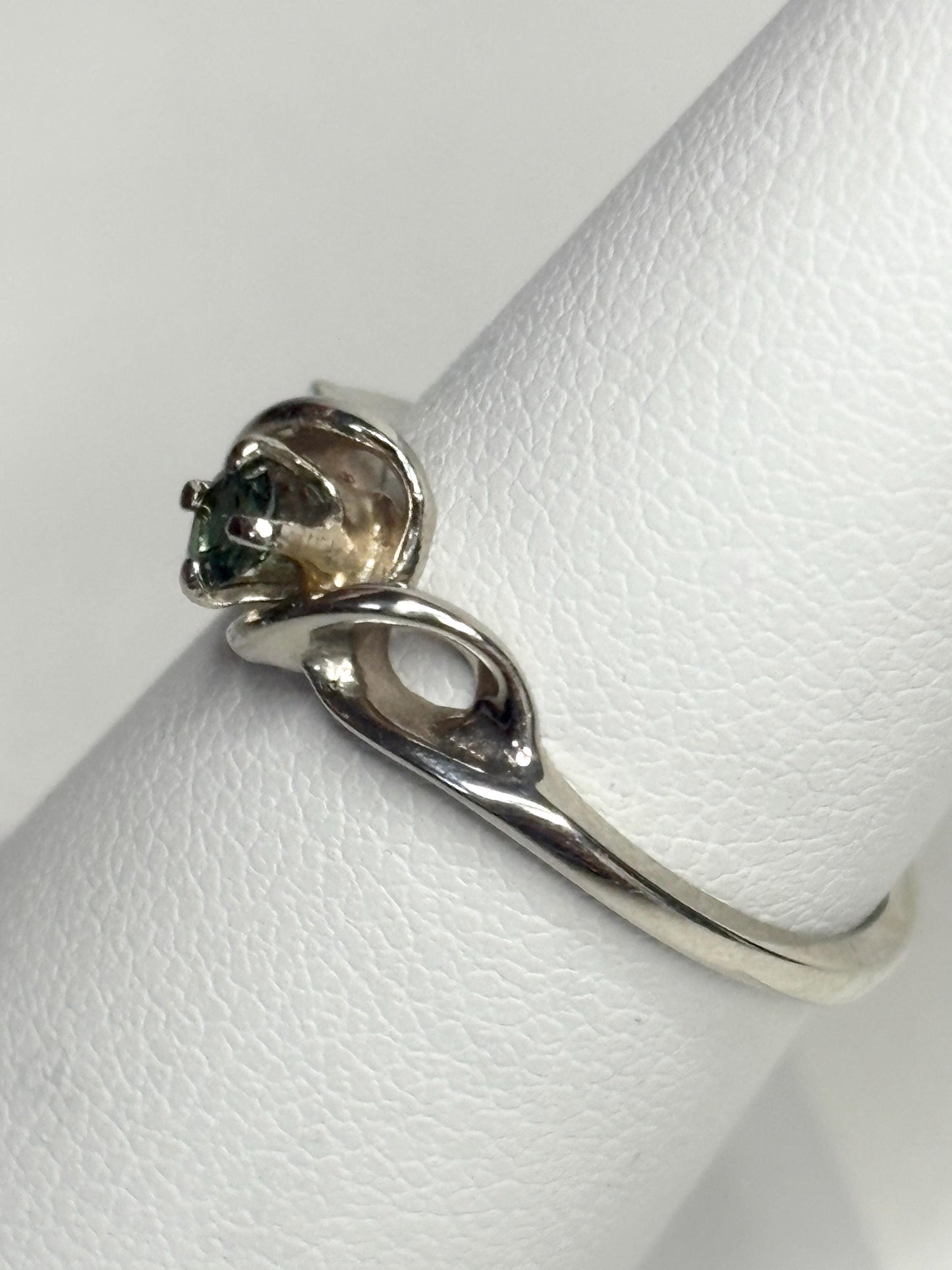 A solid 10k white gold band ring with a natural blue-green tourmaline.