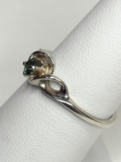 A solid 10k white gold band ring with a natural blue-green tourmaline.