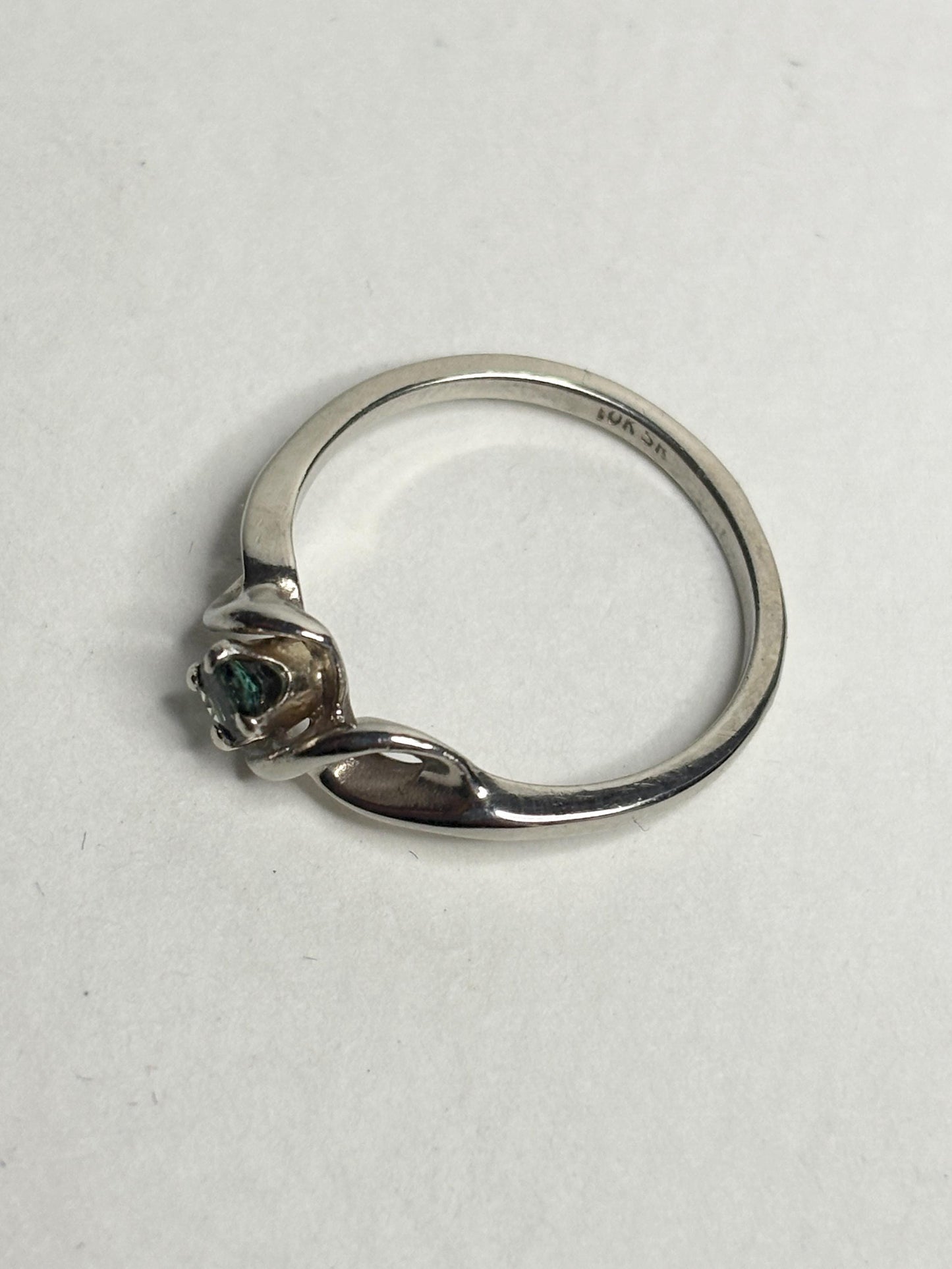 10k white gold band ring with a blue-green tourmaline gemstone.