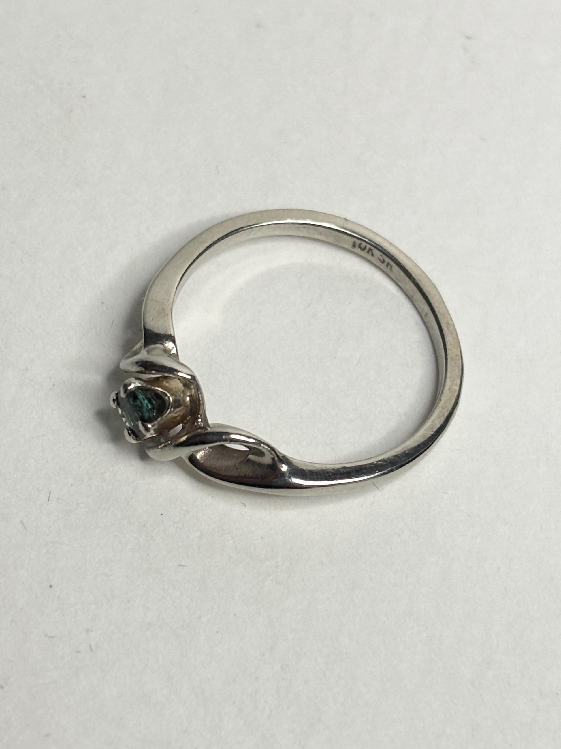10k white gold band ring with a blue-green tourmaline gemstone.