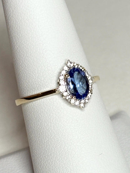 Oval tanzanite and zircon halo ring in solid 9k gold.