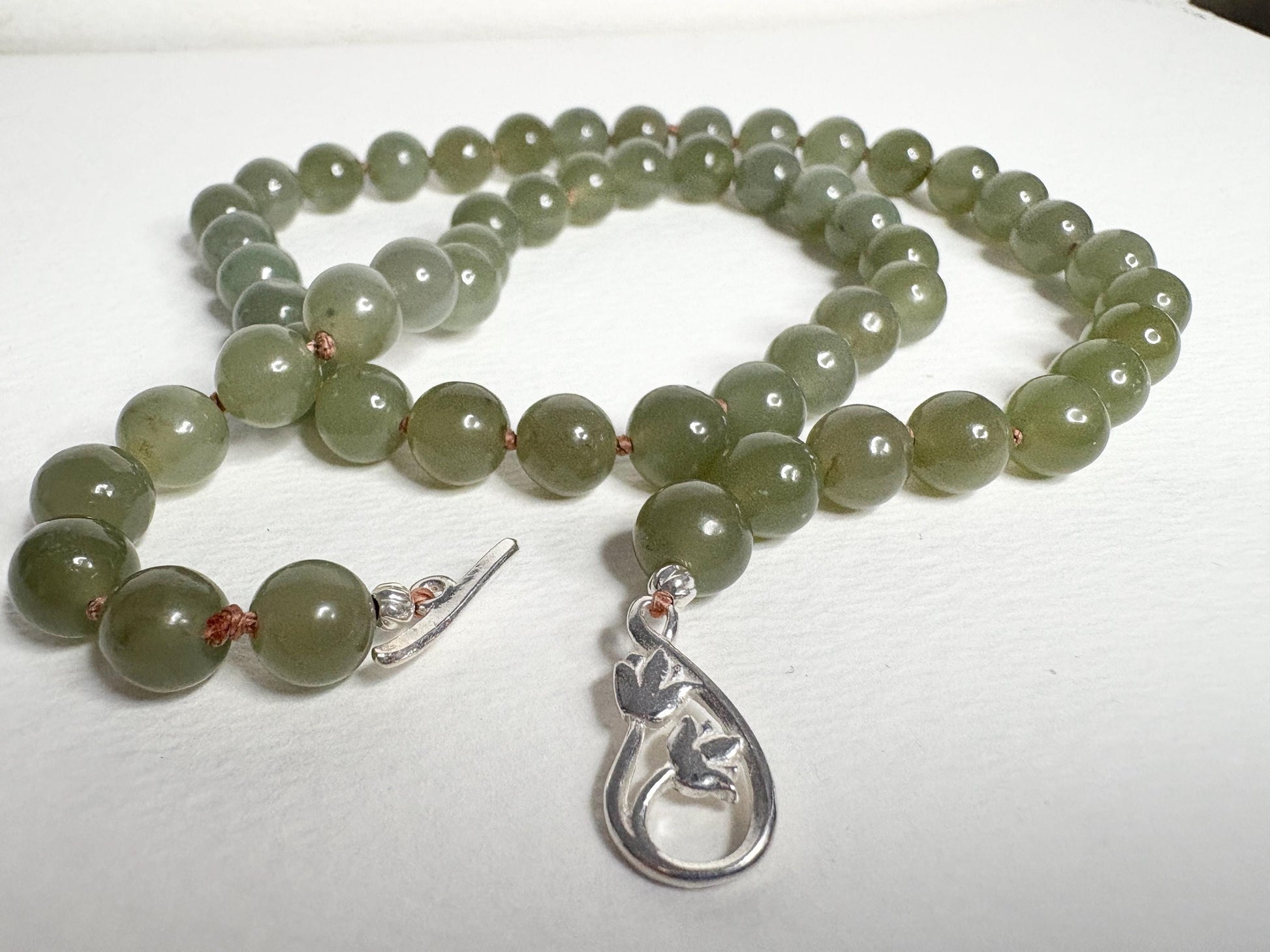 Nephrite Hetian Jade knotted bead necklace with sterling silver toggle clasp.