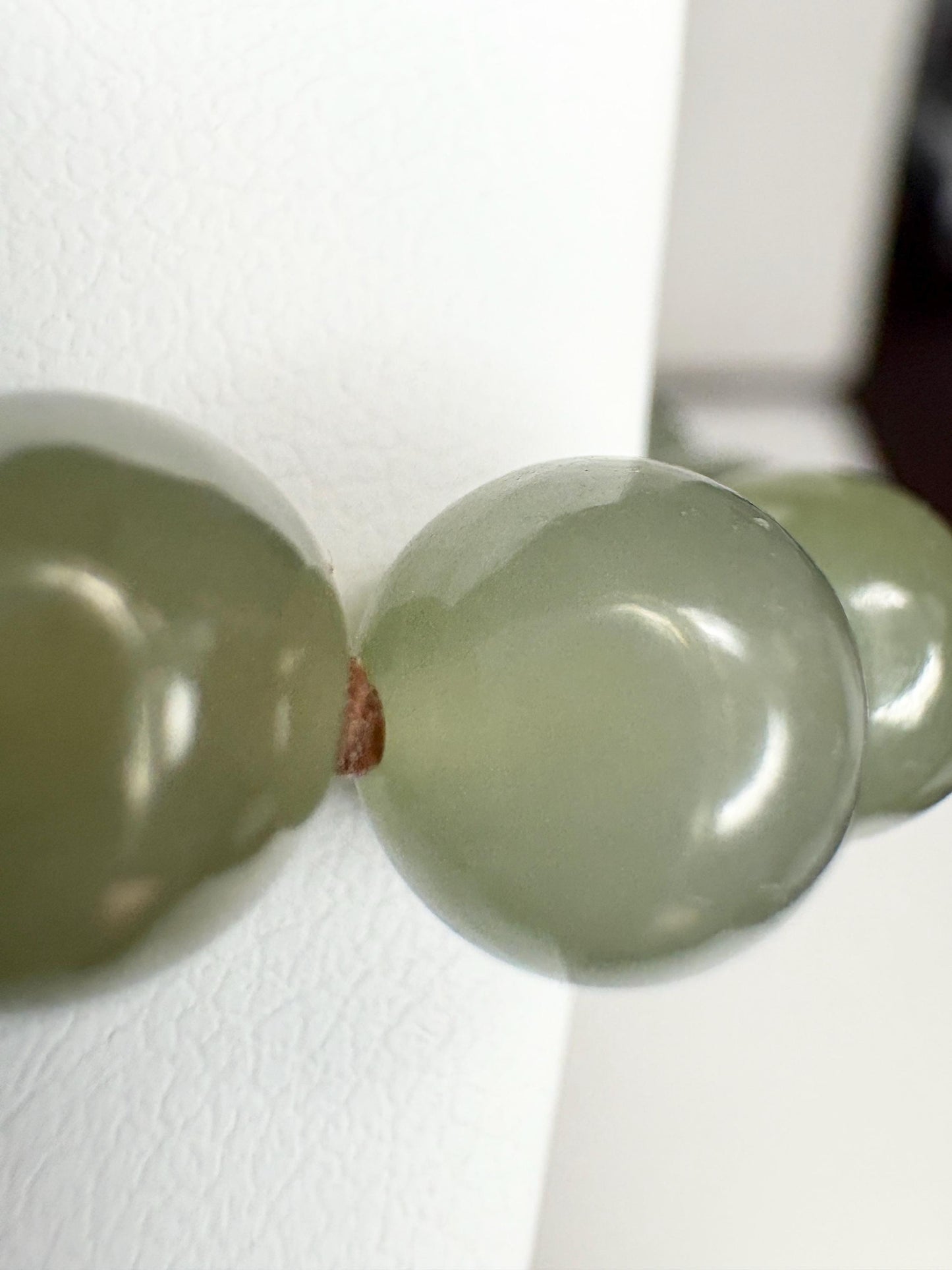 Nephrite Hetian jade knotted bead bracelet with sterling silver toggle.