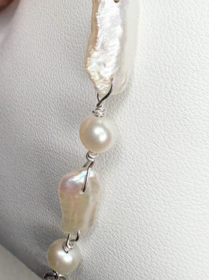 Sterling silver bracelet with white and peach freshwater pearls.
