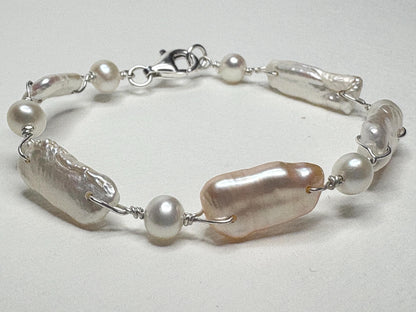 Sterling silver bracelet with white and peach biwa freshwater pearls.