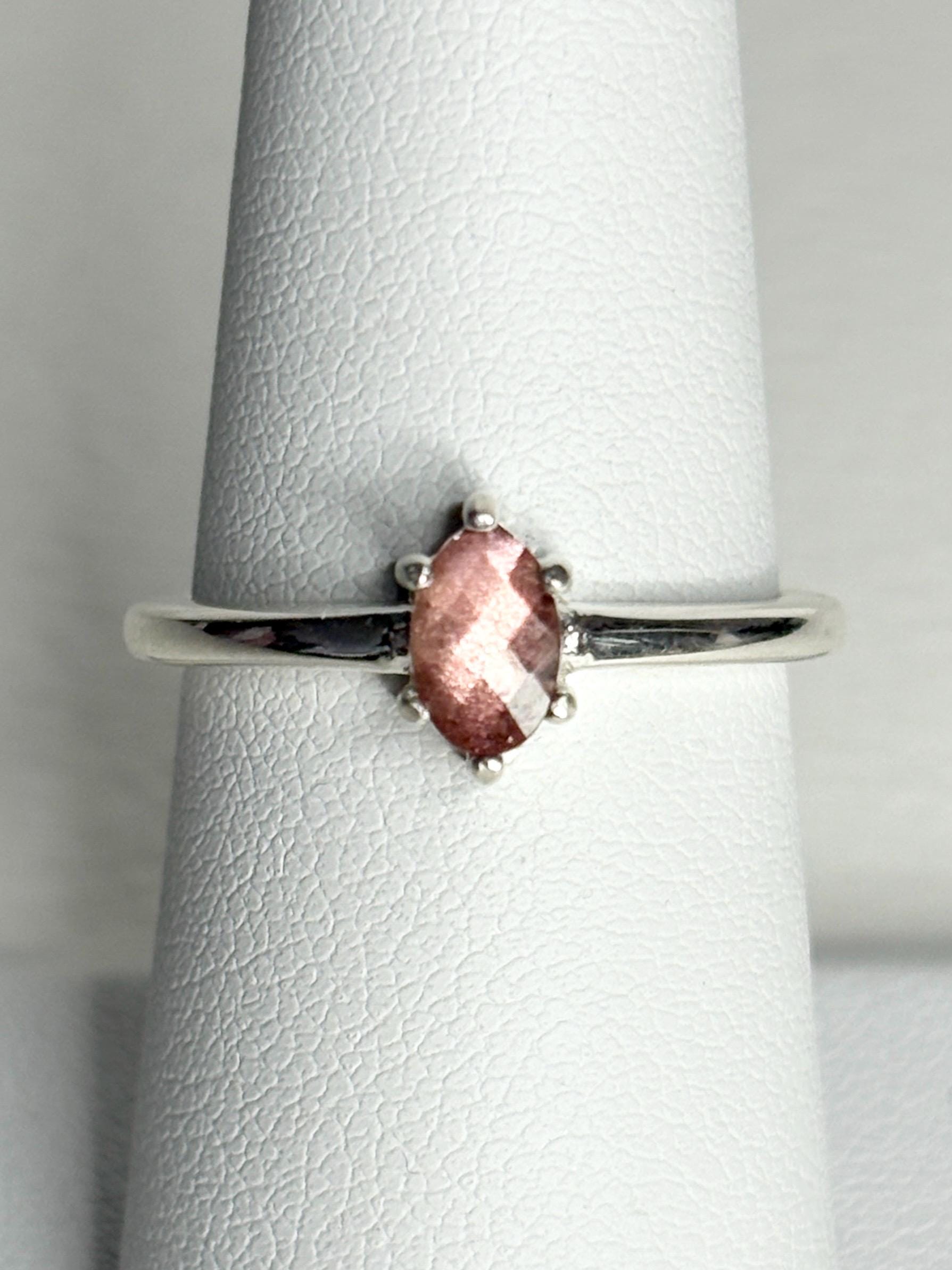 Sterling silver ring with a faceted oval Oregon sunstone.