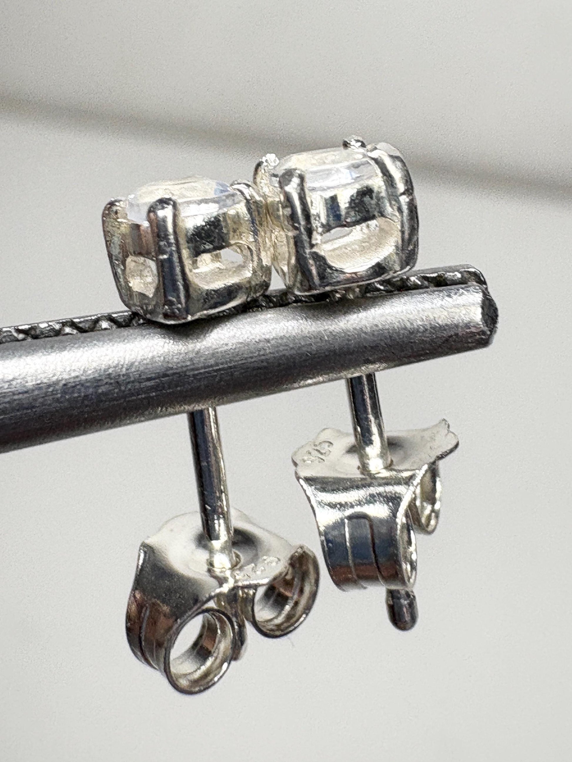 Sterling silver stud earrings with 3mm blue sheen moonstone gems.