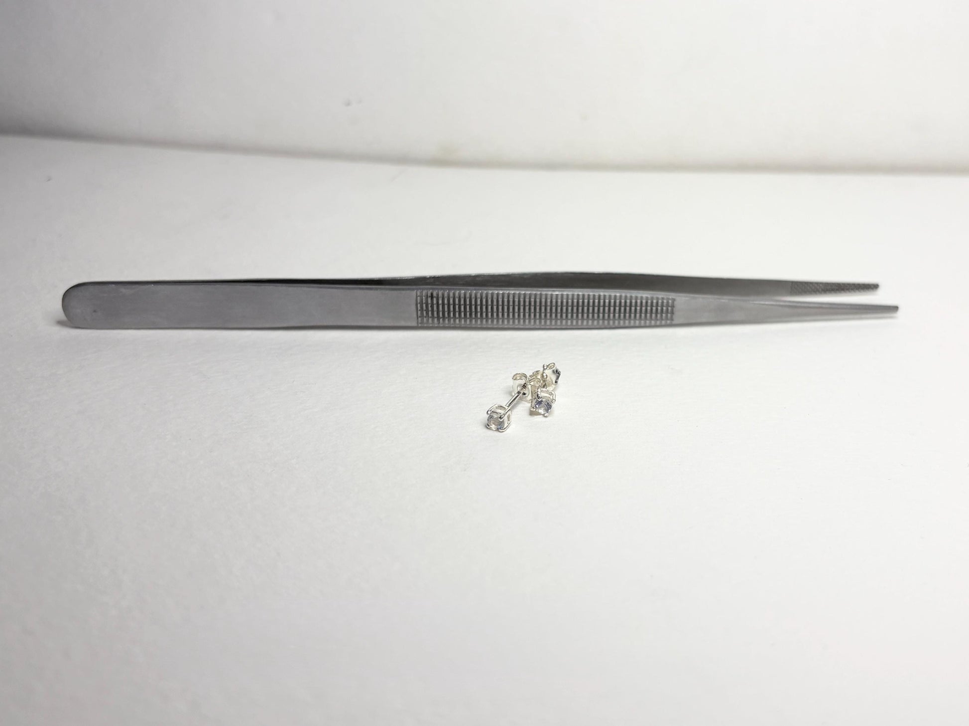 Sterling silver stud earrings with 3mm blue sheen moonstones.