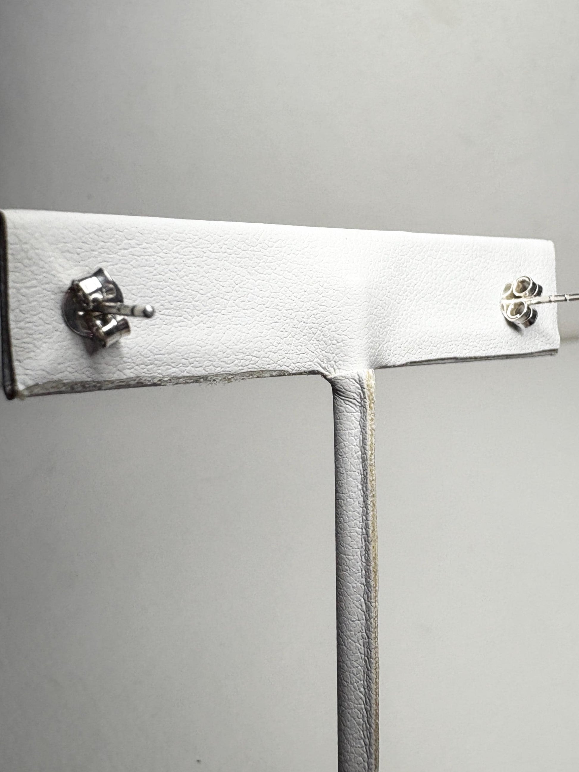 Sterling silver stud earrings with garnets and zircons.