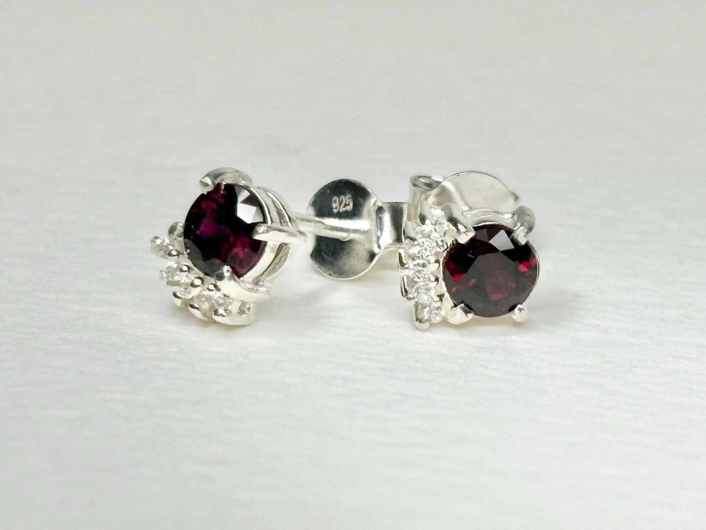 Sterling silver stud earrings with garnets and zircons.