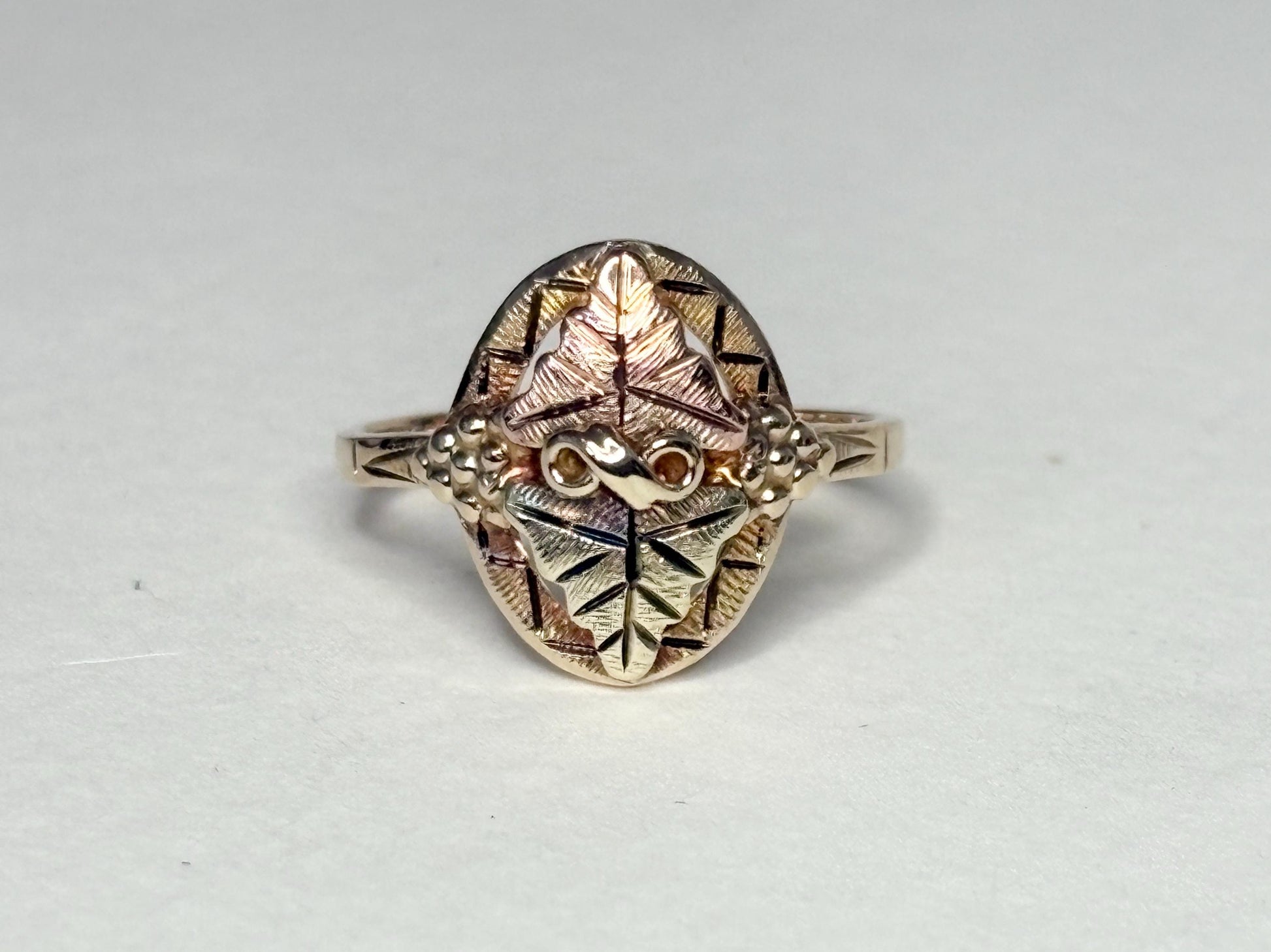 Black Hills Gold ring with 10k gold band and 12k gold leaves.