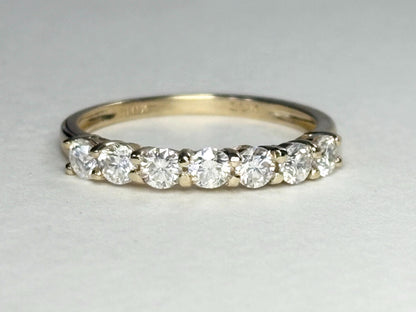 Solid 10k gold band ring with seven moissanite stones.