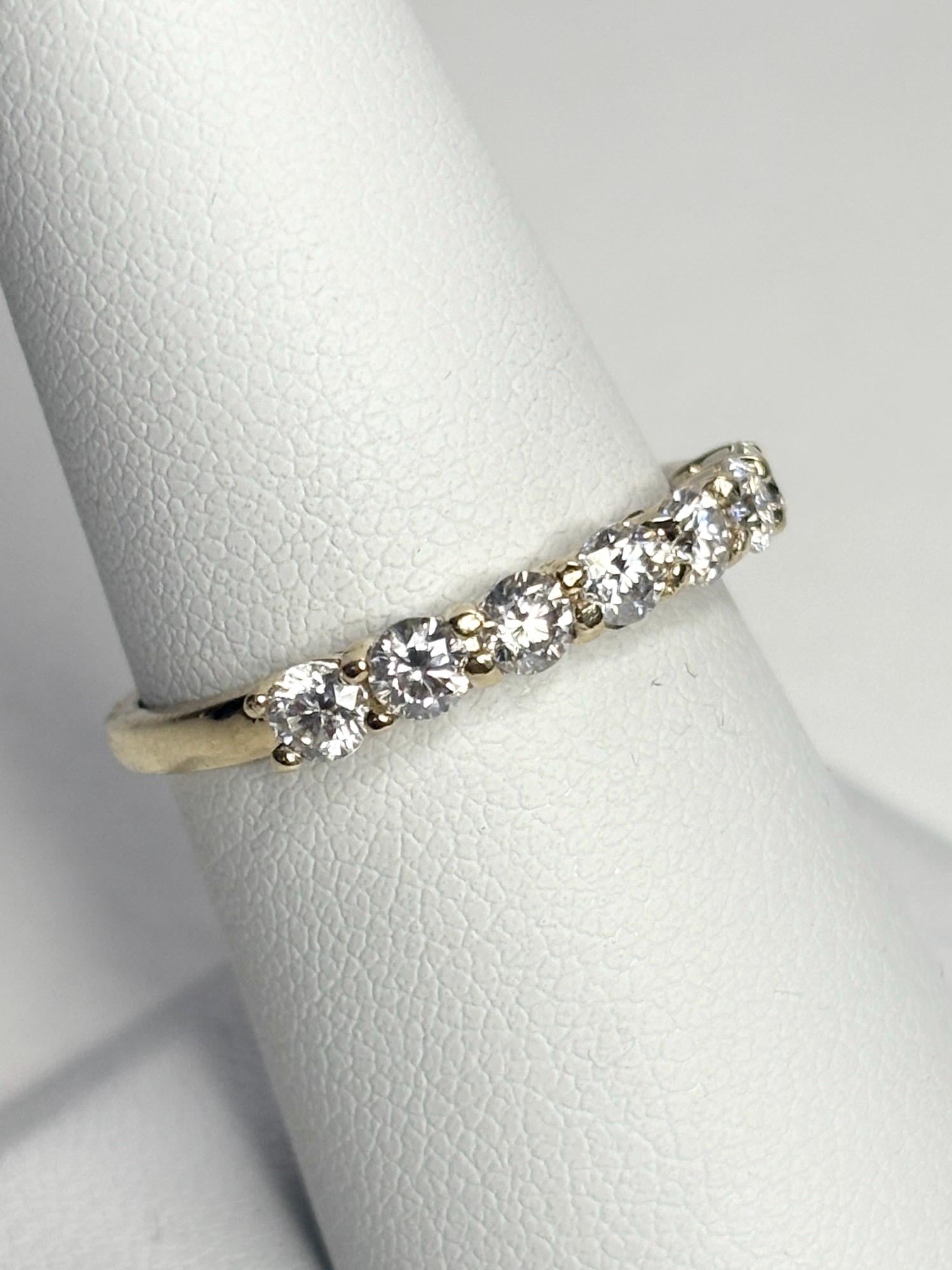 Solid 10k gold band ring with seven moissanite stones.