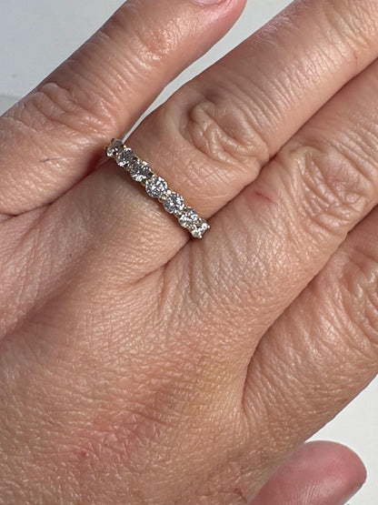 Solid 10k gold stackable band ring with seven moissanite stones.