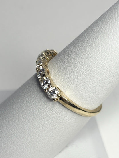 Solid 10k yellow gold anniversary band with seven moissanite stones.