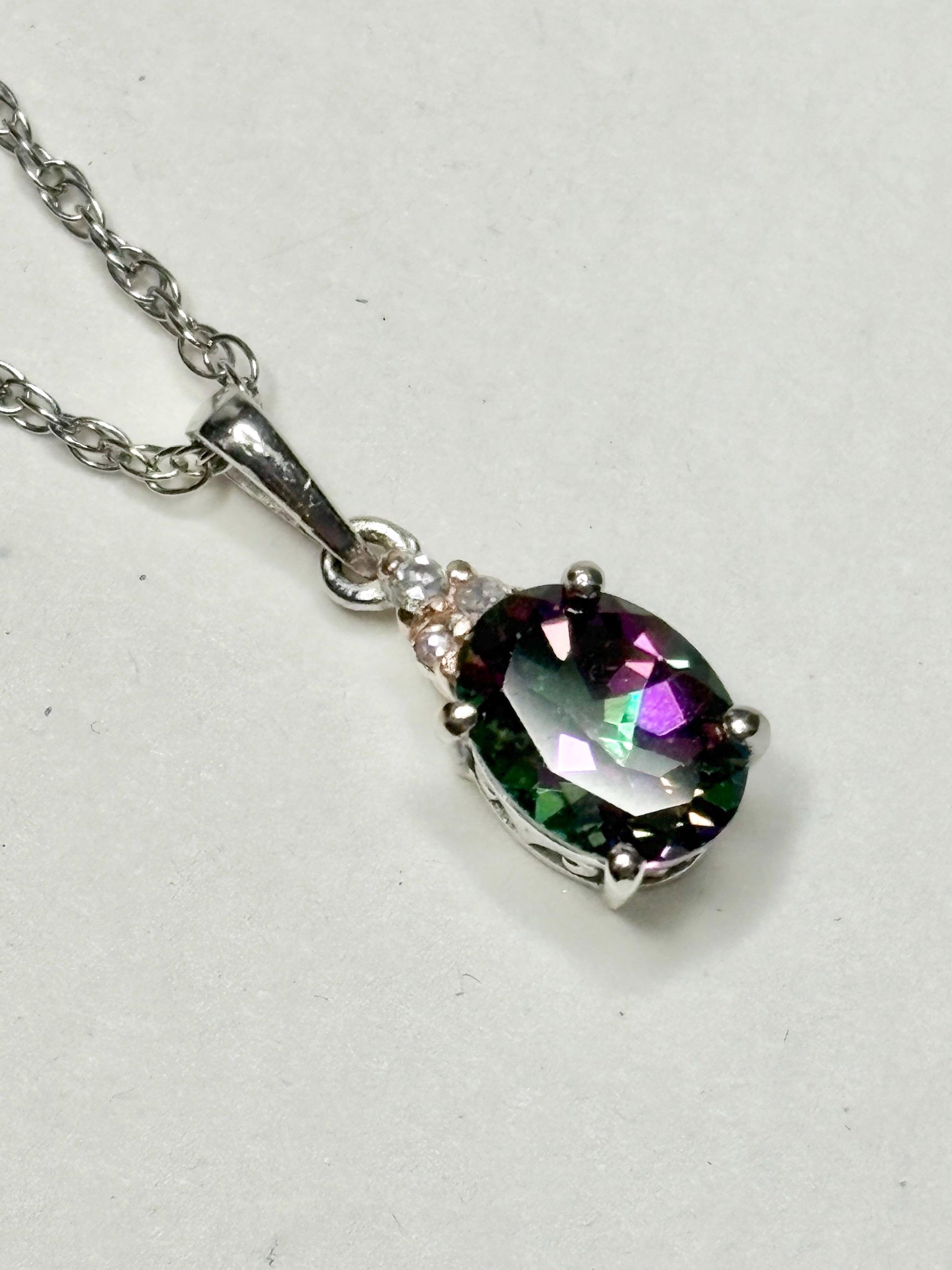 Sterling silver pendant necklace with oval mystic topaz and lab-grown diamonds.