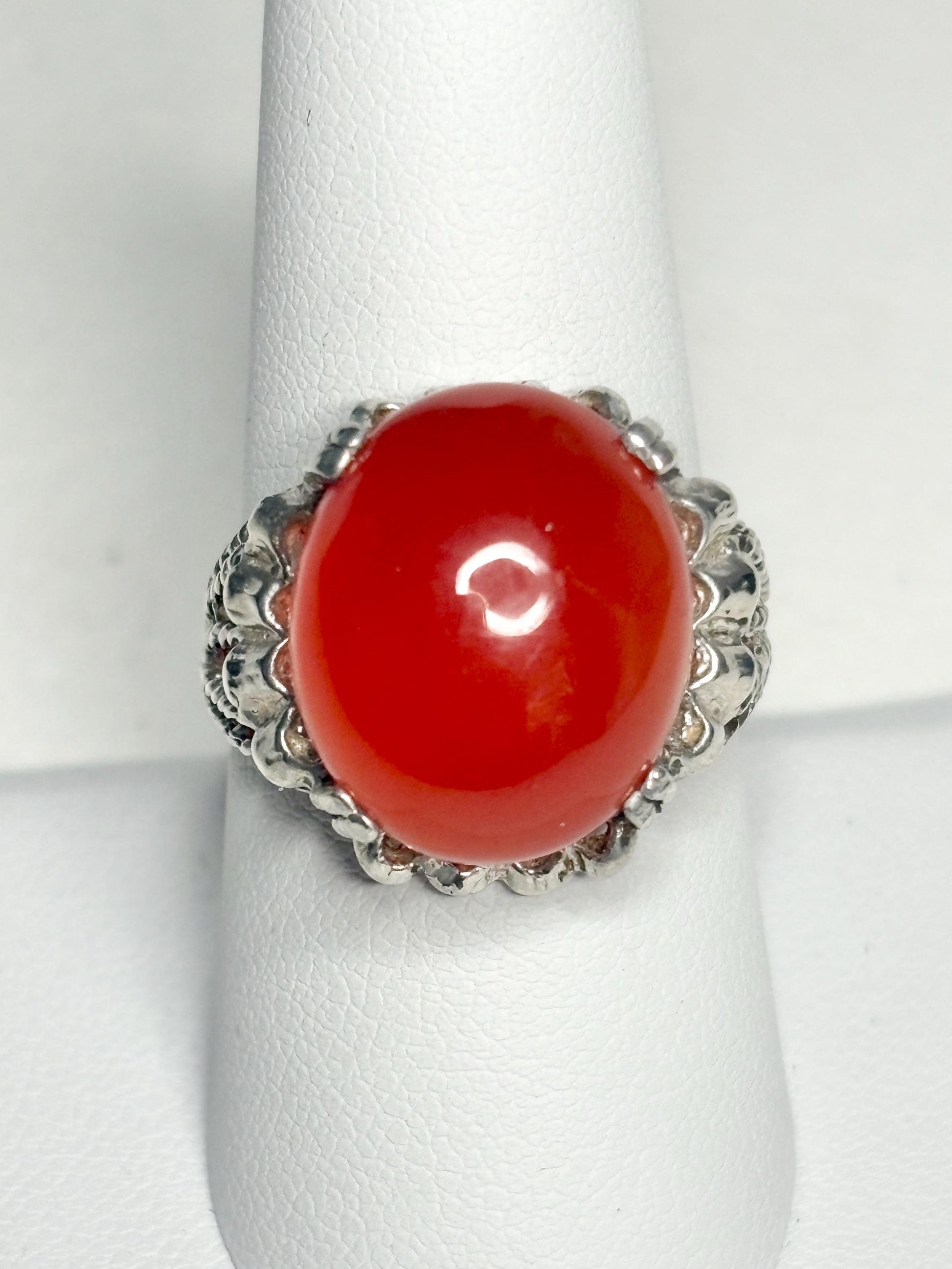 Sterling silver ring with a large, round, bright red carnelian cabochon.
