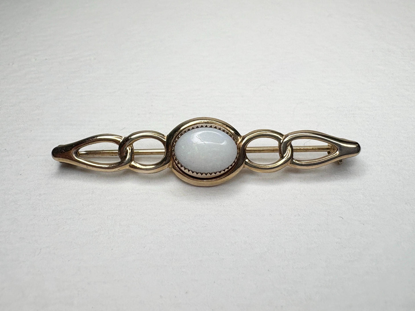 Australian white opal bar brooch in solid 14k gold.