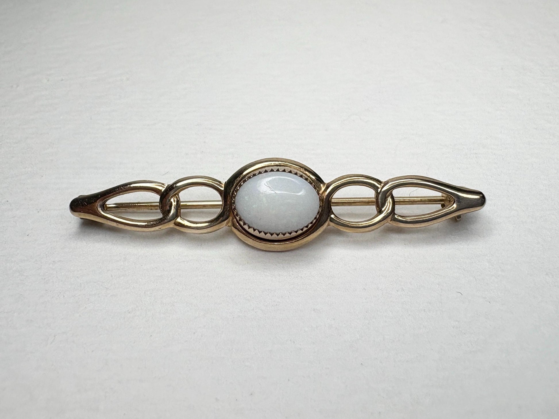 Australian white opal bar brooch in solid 14k gold.
