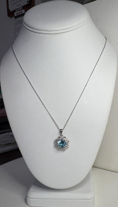 Sterling silver pendant necklace with blue topaz and moissanite.