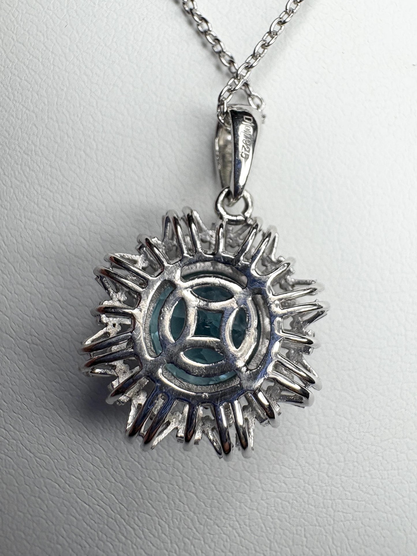 Sterling silver pendant necklace with blue topaz and moissanite.