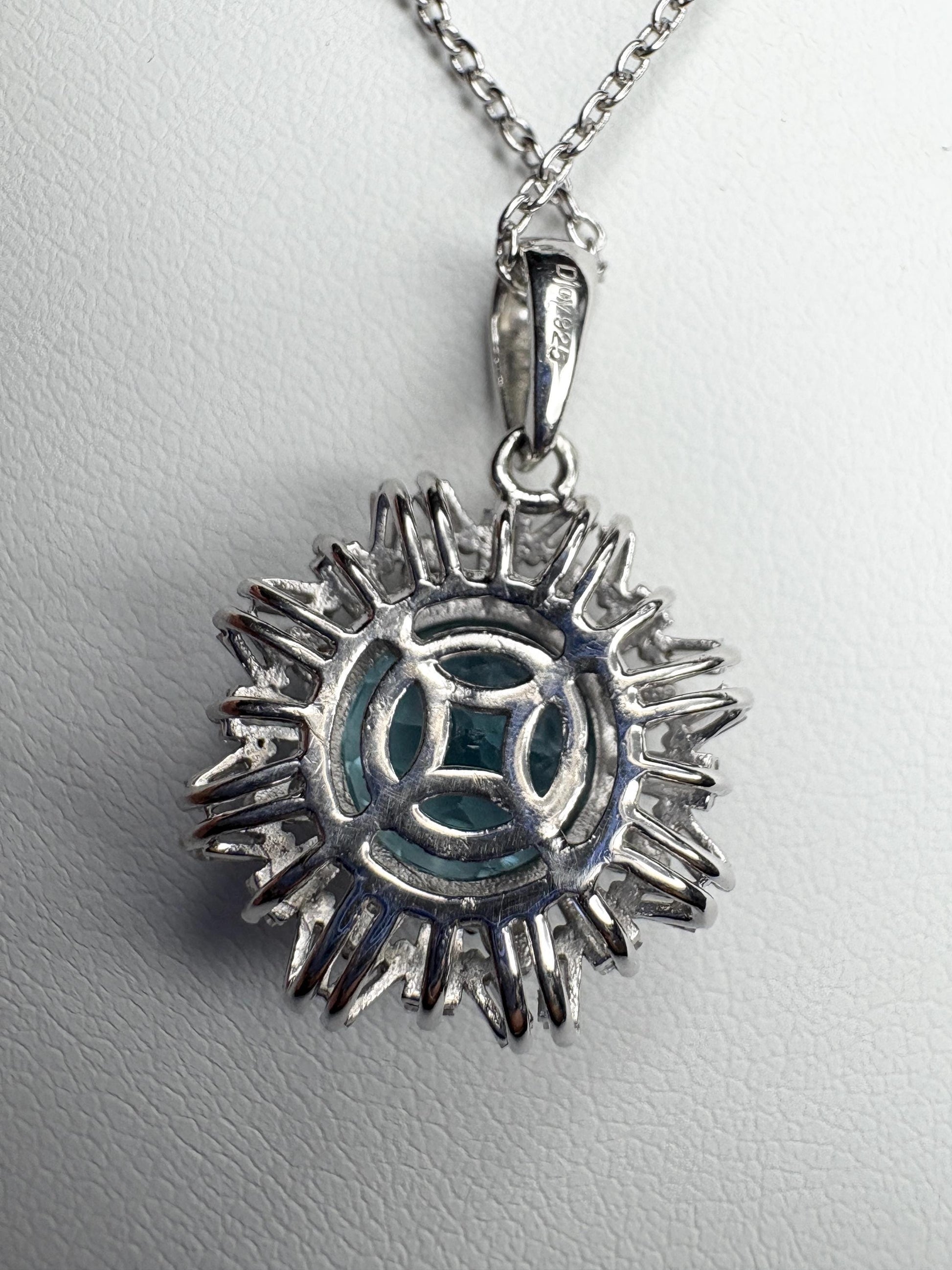 Sterling silver pendant necklace with blue topaz and moissanite.