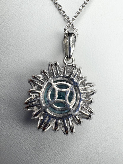 Sterling silver pendant necklace with blue topaz and moissanite.
