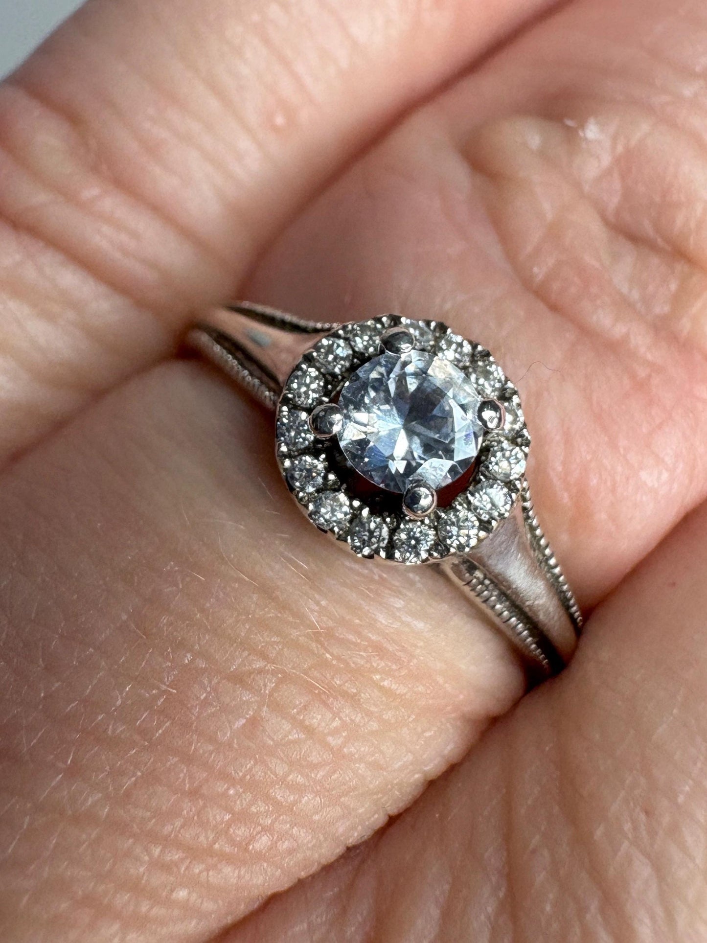 Sterling silver ring with white sapphire and diamond halo.