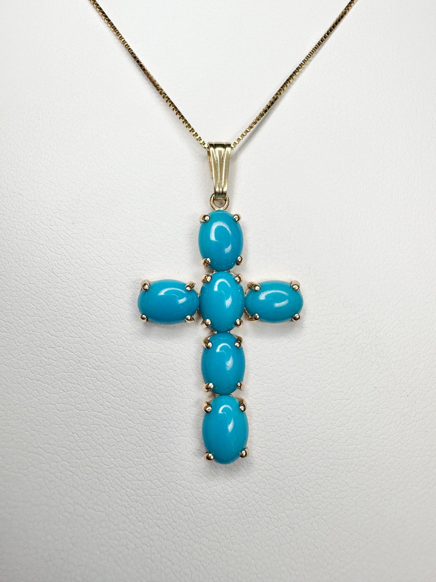 14k gold cross pendant necklace with six oval Sleeping Beauty turquoise stones.