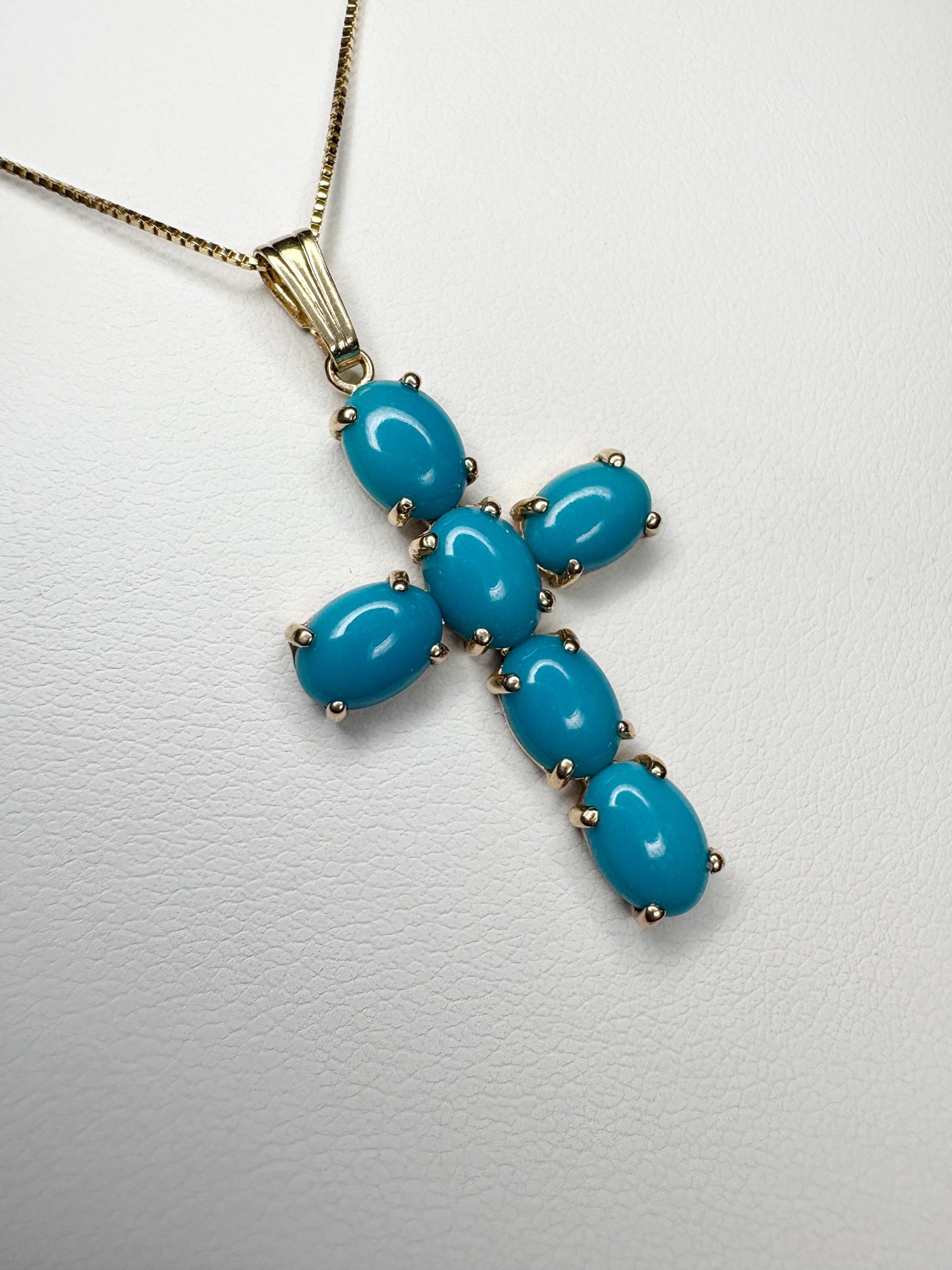 14k gold cross pendant necklace with six oval Sleeping Beauty turquoise stones.