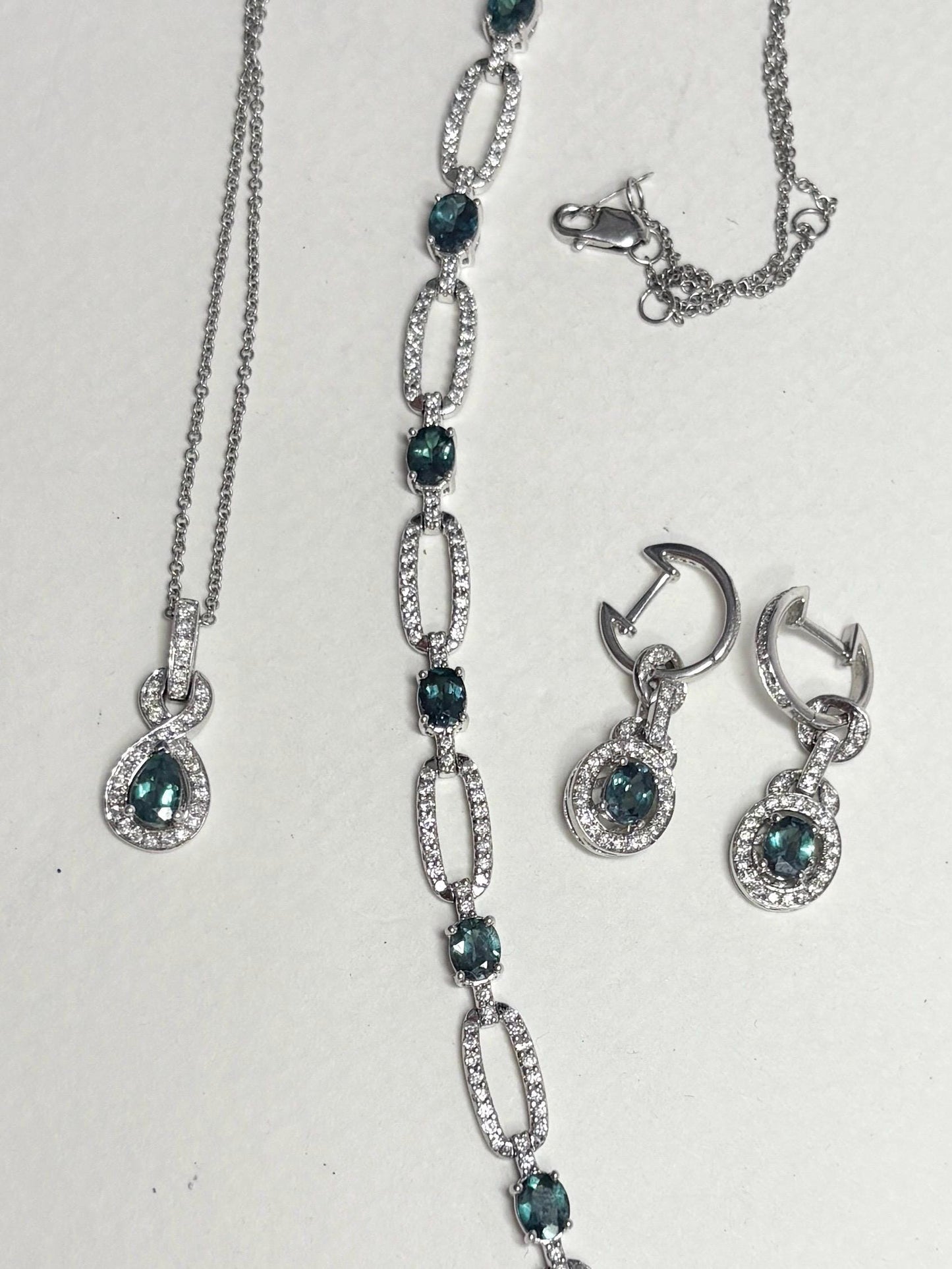 A white gold bracelet with oval alexandrite stones and diamonds.