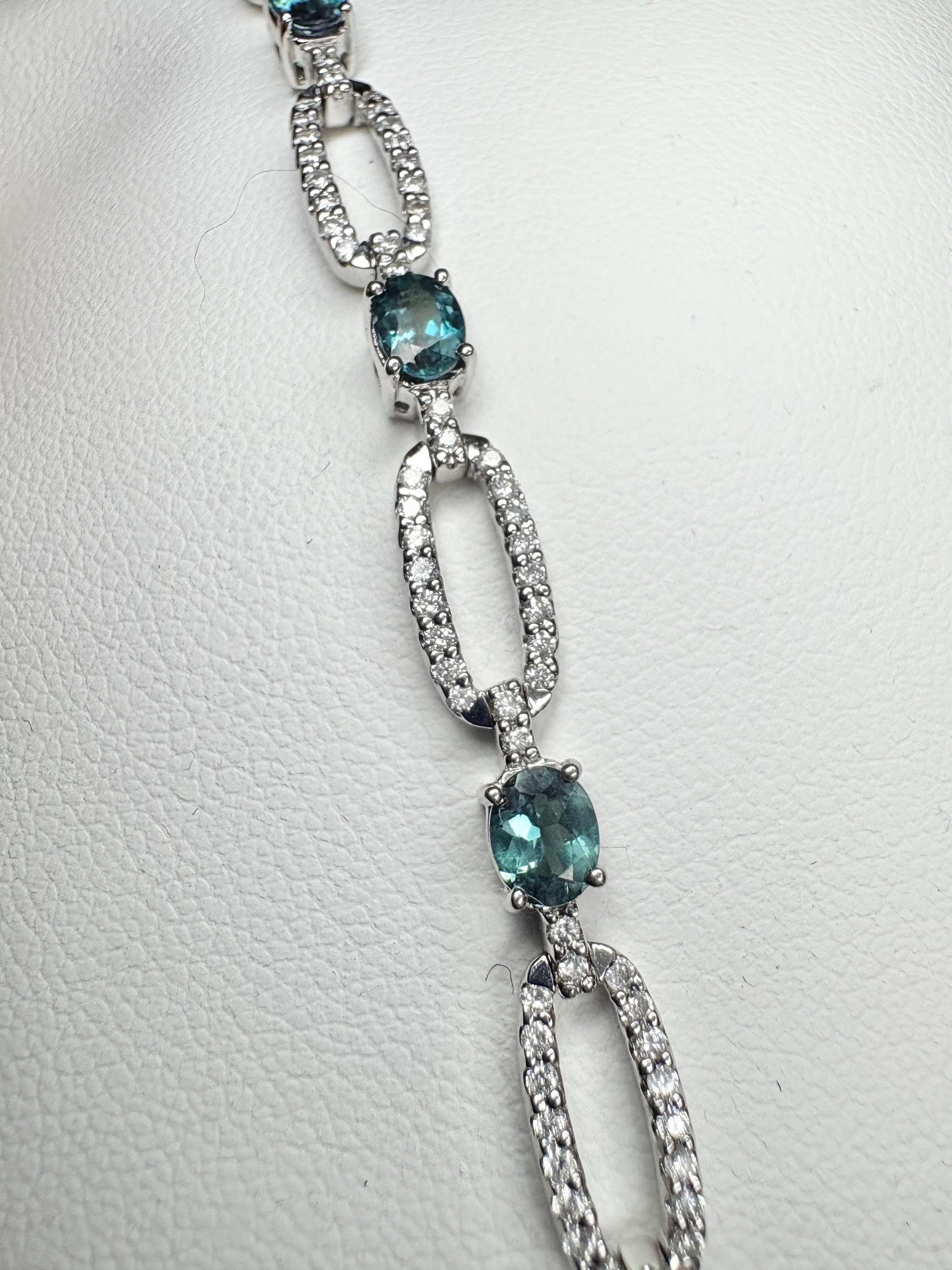 A white gold bracelet with oval alexandrite stones and diamonds.