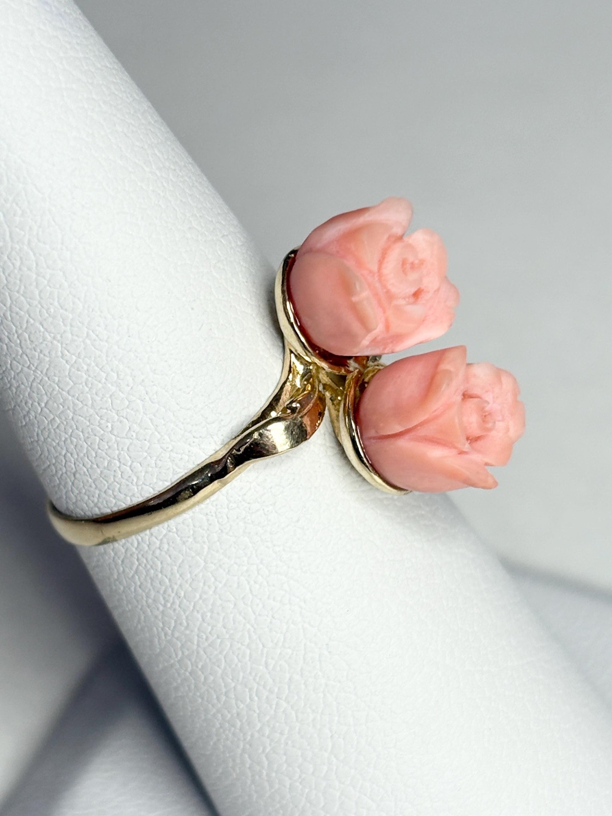 A 10k gold ring featuring two angel skin coral rose buds.