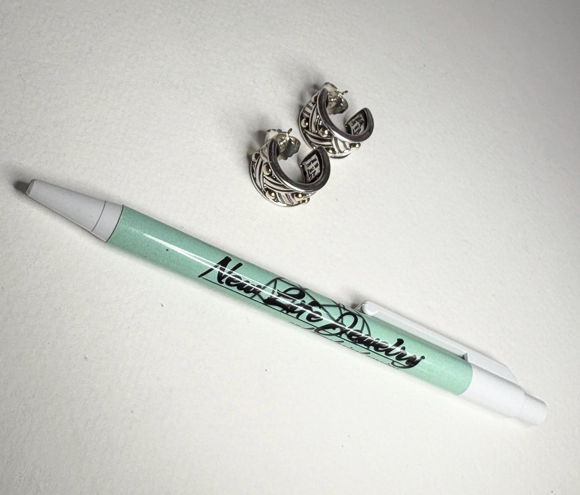 Ann King wide woven dotted hoop earrings in 18k gold and sterling silver.