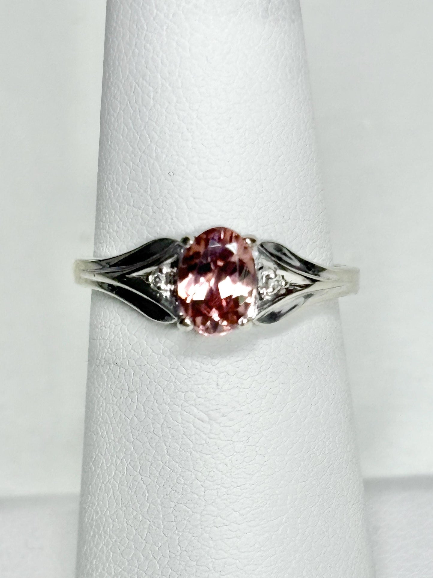 Oval blush pink zircon ring with diamond accents in 10k white gold.