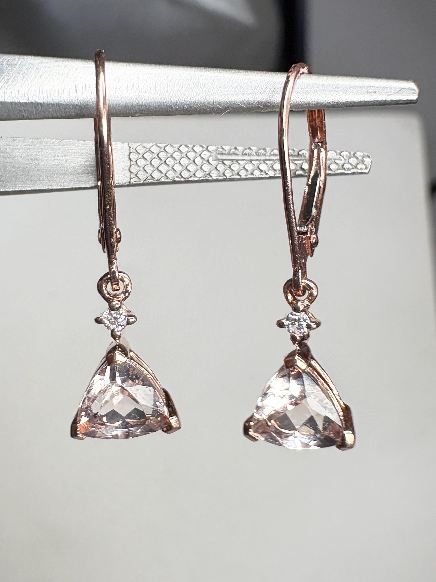 Rose gold dangle earrings with trillion morganite and diamond accents.