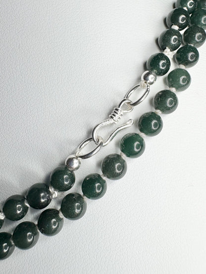 Teal jadeite jade beads with a sterling silver clasp.
