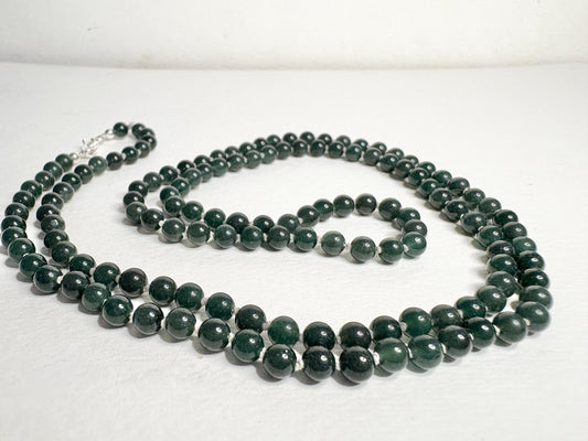 A long teal jadeite jade beaded necklace with a sterling silver clasp.