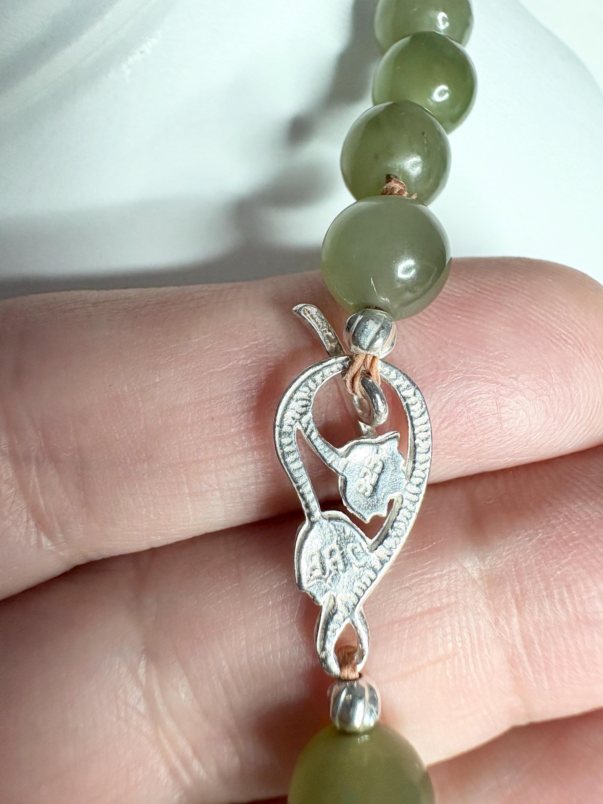 Nephrite Hetian Jade beaded bracelet with sterling silver lotus toggle clasp.