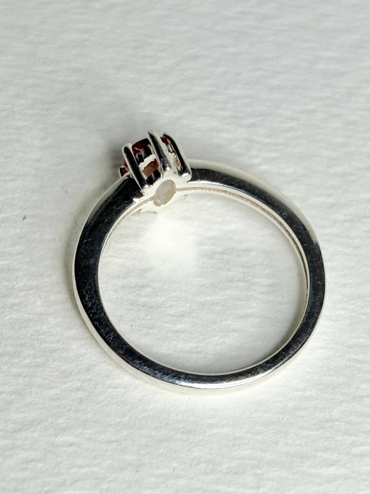 Sterling silver ring with a faceted peach Oregon sunstone.