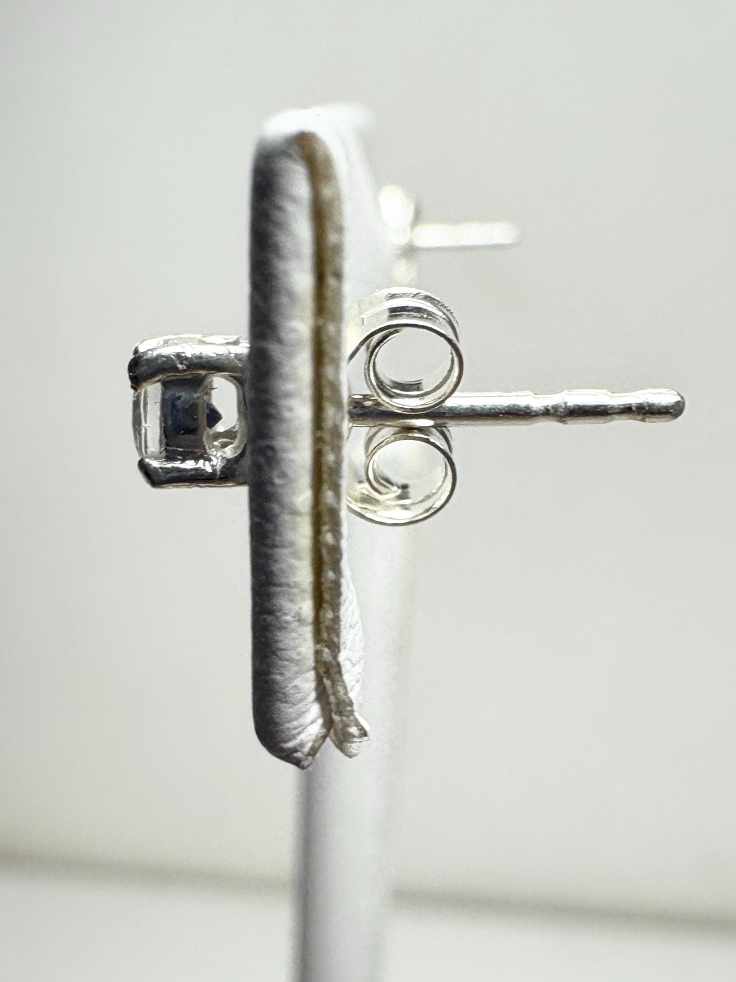 Sterling silver stud earrings with 3mm blue sheen moonstone gems.