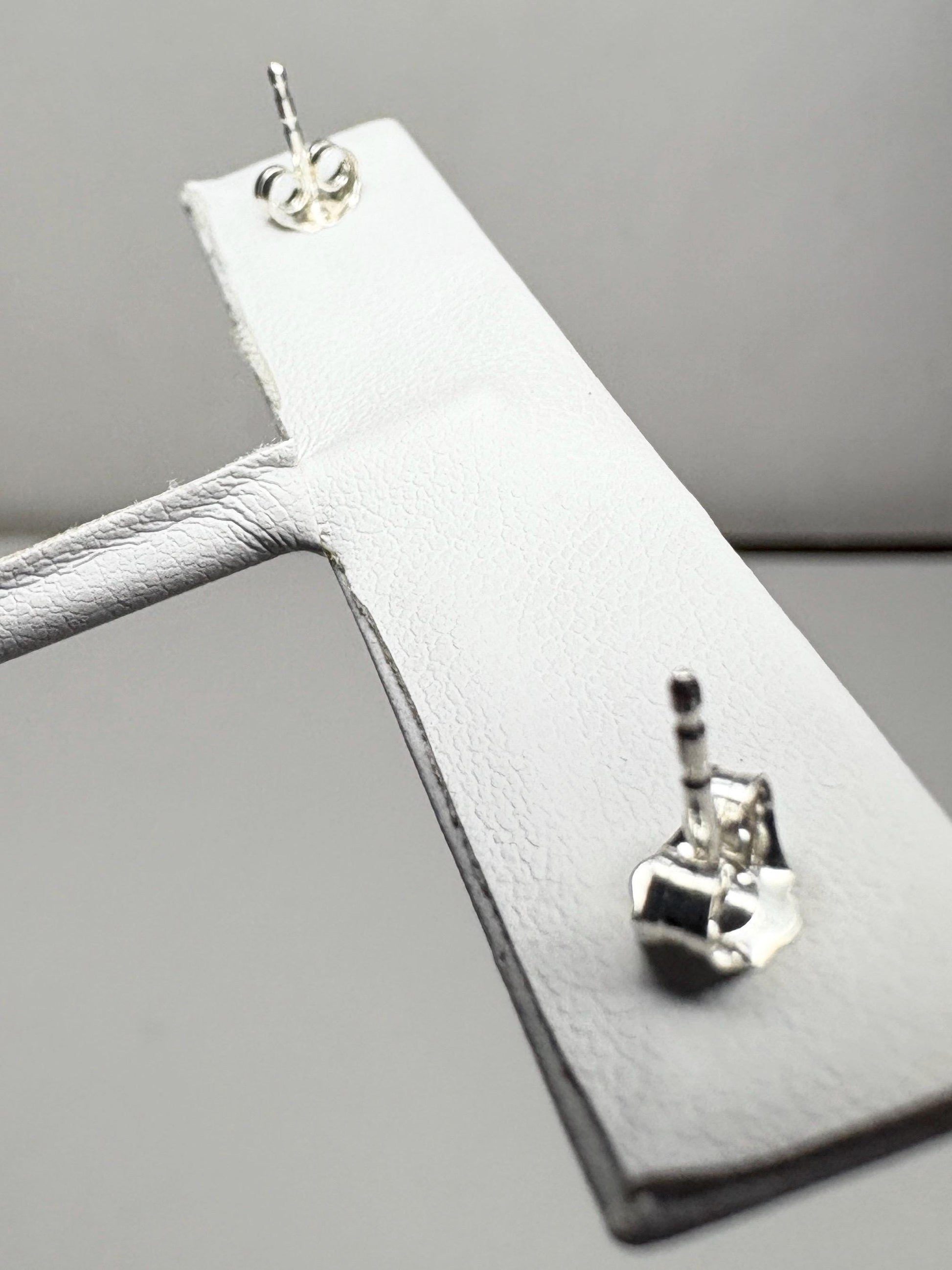 Sterling silver stud earrings with blue sheen moonstone.