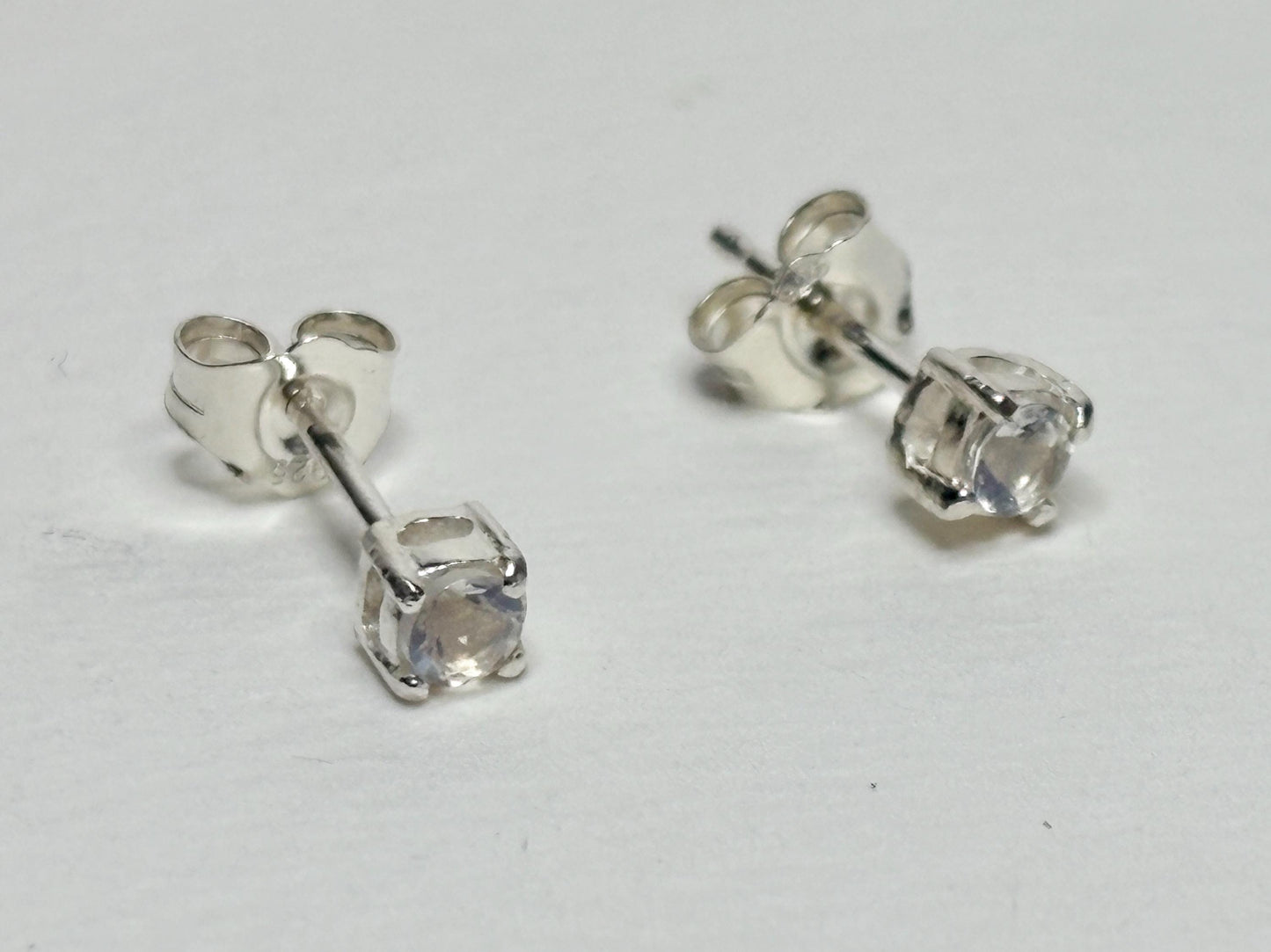 Sterling silver stud earrings with 3mm blue sheen moonstone gems.