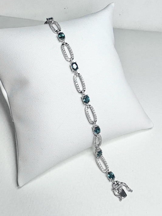 A white gold bracelet with oval alexandrite stones and diamonds.